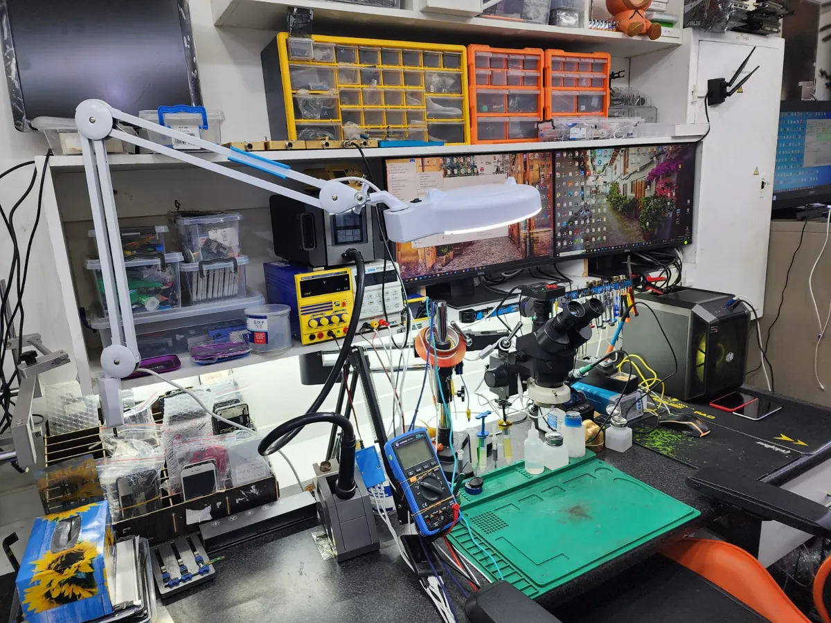 PC Vitamins repair workbench with professional diagnostic equipment and soldering tools
