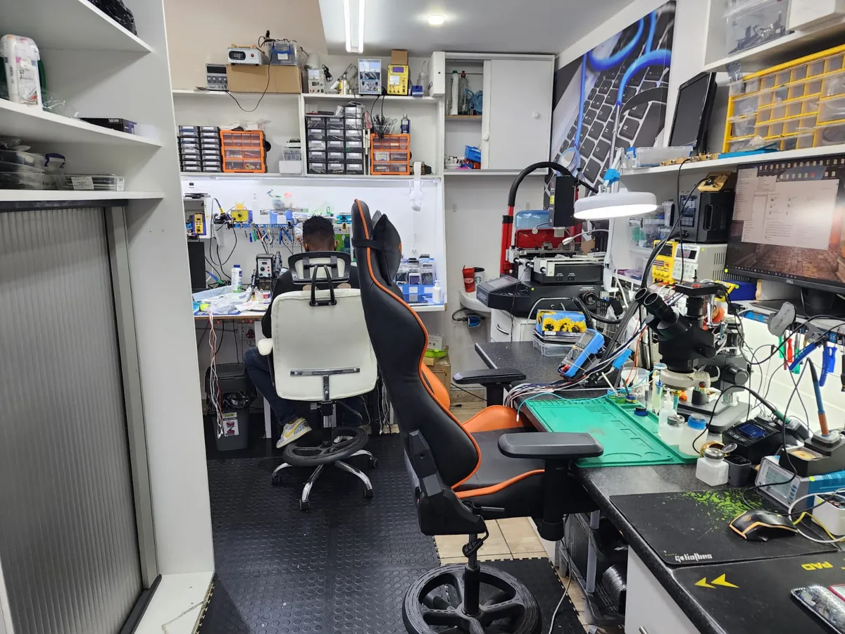 PC Vitamins technician working on a device at the repair workbench