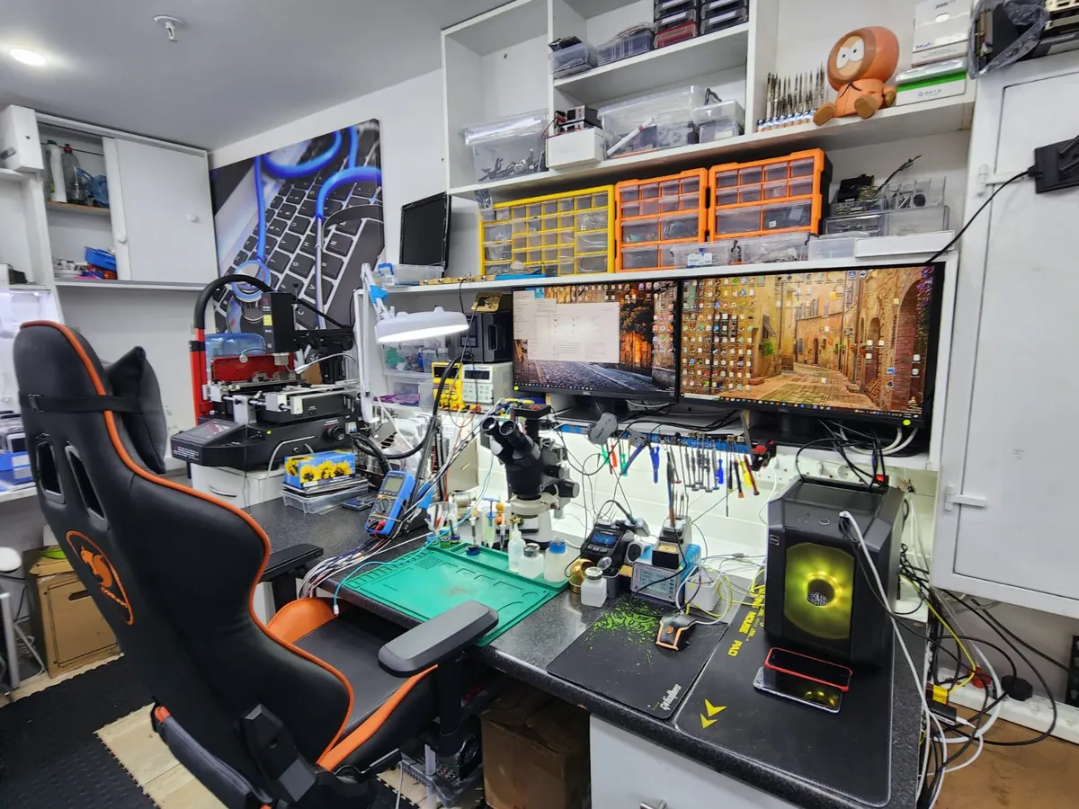PC Vitamins repair workbench with professional soldering and diagnostic equipment